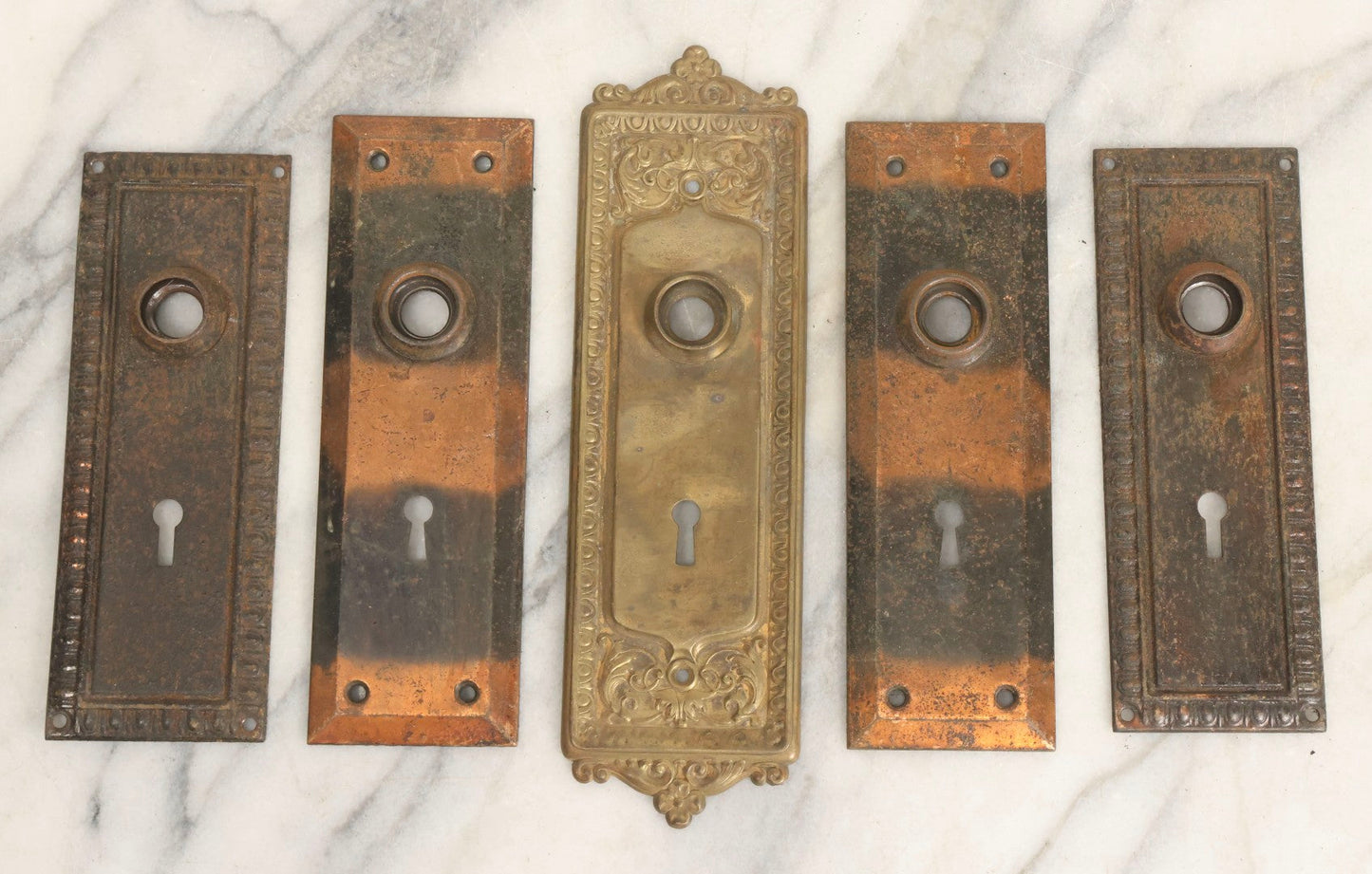 Lot 079 - Antique Door Hardware Grouping With Two Pairs Of Sheet Metal Escutcheons And One Pressed Brass Escutcheon