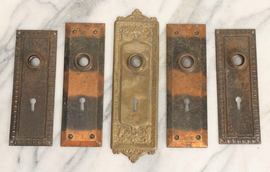 Lot 079 - Antique Door Hardware Grouping With Two Pairs Of Sheet Metal Escutcheons And One Pressed Brass Escutcheon