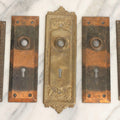 Lot 079 - Antique Door Hardware Grouping With Two Pairs Of Sheet Metal Escutcheons And One Pressed Brass Escutcheon