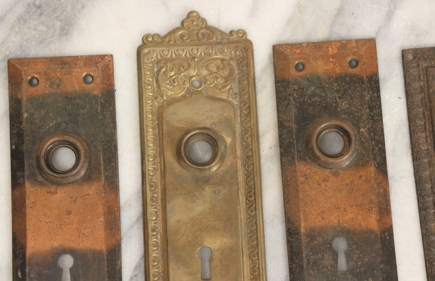 Lot 079 - Antique Door Hardware Grouping With Two Pairs Of Sheet Metal Escutcheons And One Pressed Brass Escutcheon