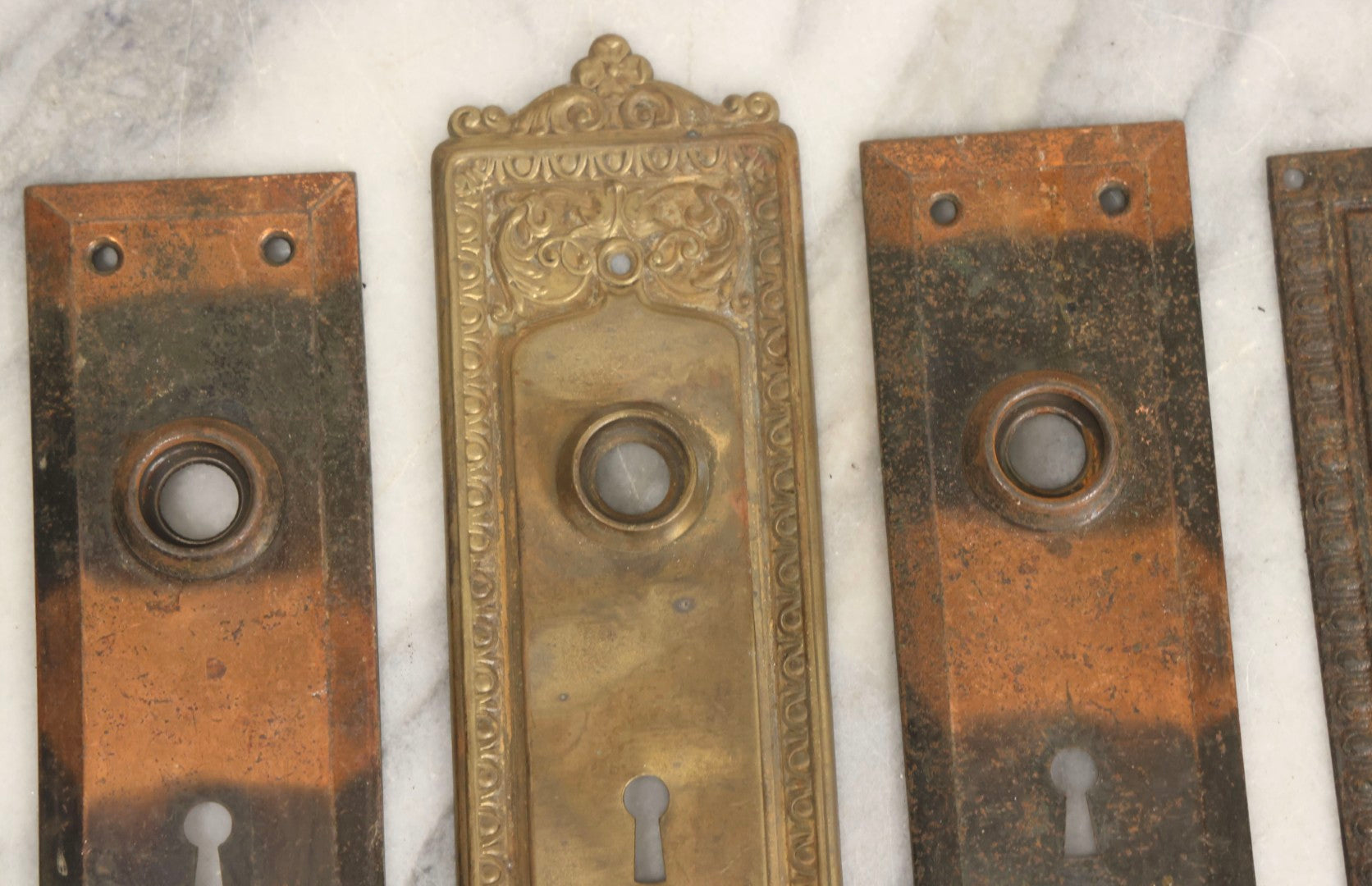 Lot 079 - Antique Door Hardware Grouping With Two Pairs Of Sheet Metal Escutcheons And One Pressed Brass Escutcheon