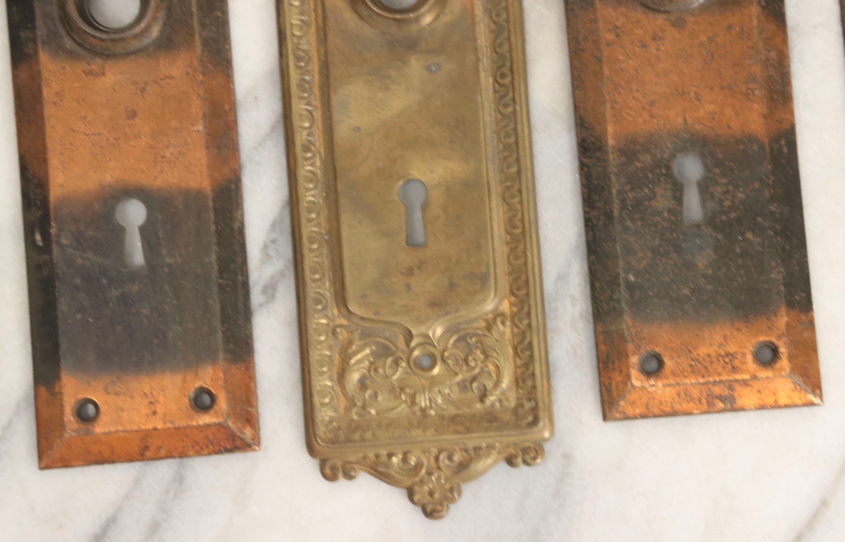 Lot 079 - Antique Door Hardware Grouping With Two Pairs Of Sheet Metal Escutcheons And One Pressed Brass Escutcheon
