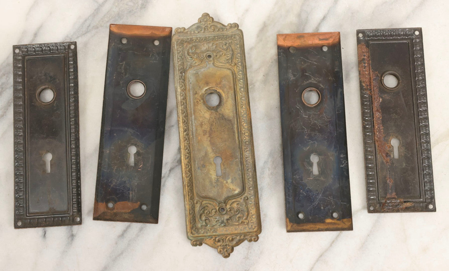Lot 079 - Antique Door Hardware Grouping With Two Pairs Of Sheet Metal Escutcheons And One Pressed Brass Escutcheon