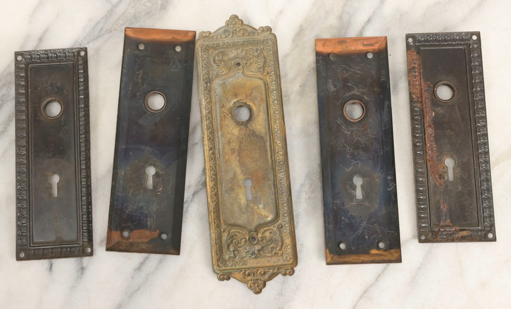 Lot 079 - Antique Door Hardware Grouping With Two Pairs Of Sheet Metal Escutcheons And One Pressed Brass Escutcheon