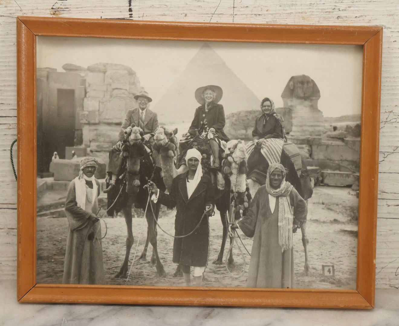 Lot 088 - Vintage Black And White Tourism Photograph Of Three Tourists On Camels At The Giza Pyramids With Great Sphinx, Egypt, In Modern Frame