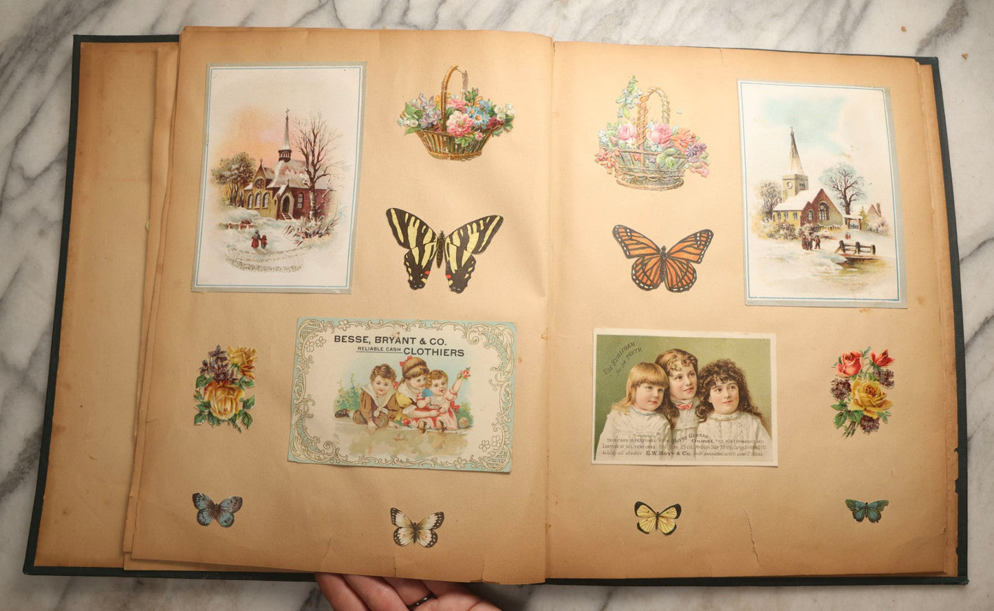 Lot 096 - Antique "The Nonpareil" Scrapbook, Puppies Illustration On Cover, With 100+ Trade Cards, Die Cuts, And Greeting Cards Featuring Children, Butterflies, And Flowers, Circa 1900-1906, Note Binding Detached