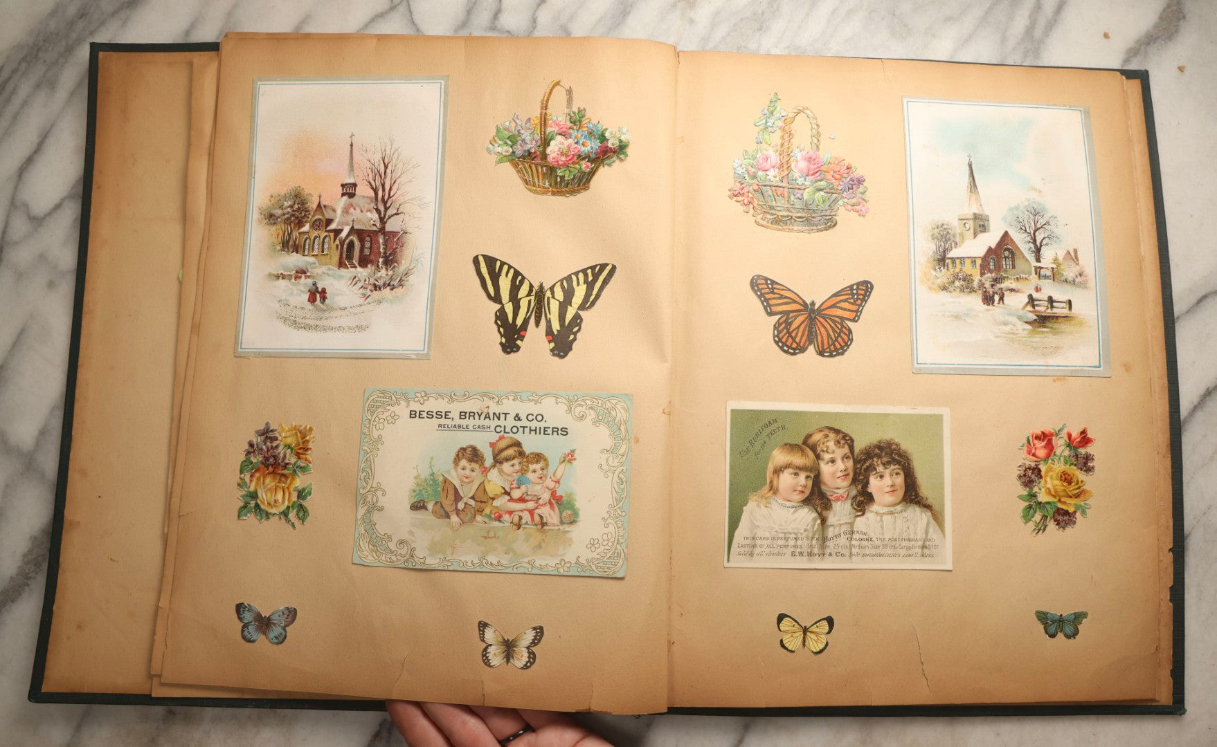 Lot 096 - Antique "The Nonpareil" Scrapbook, Puppies Illustration On Cover, With 100+ Trade Cards, Die Cuts, And Greeting Cards Featuring Children, Butterflies, And Flowers, Circa 1900-1906, Note Binding Detached