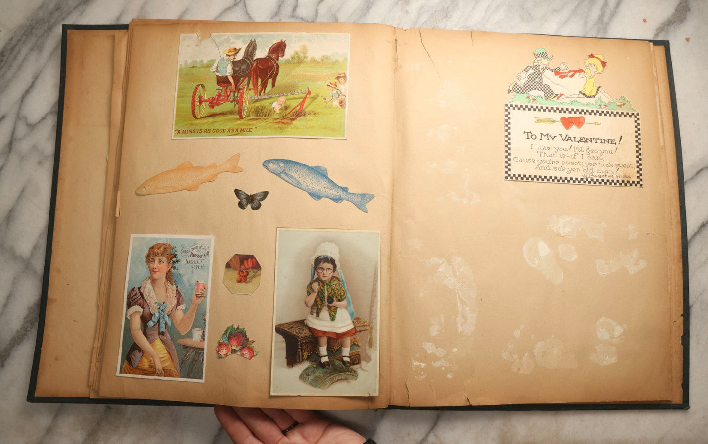 Lot 096 - Antique "The Nonpareil" Scrapbook, Puppies Illustration On Cover, With 100+ Trade Cards, Die Cuts, And Greeting Cards Featuring Children, Butterflies, And Flowers, Circa 1900-1906, Note Binding Detached
