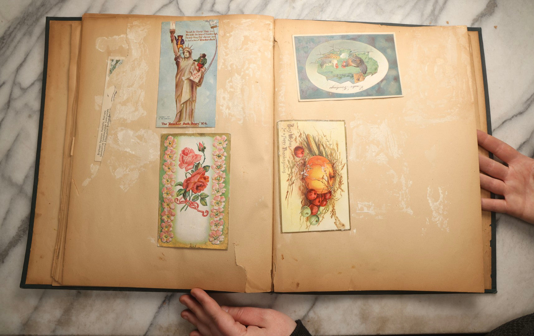 Lot 096 - Antique "The Nonpareil" Scrapbook, Puppies Illustration On Cover, With 100+ Trade Cards, Die Cuts, And Greeting Cards Featuring Children, Butterflies, And Flowers, Circa 1900-1906, Note Binding Detached