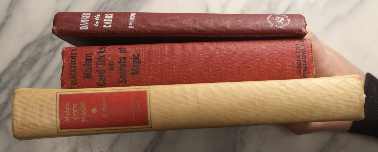 Lot 104 - Grouping Of Three Vintage Magic Books Including "Danger In The Cards" By Michael Macdougall, "Modern Coin Magic" By J.B. Bobo, And "Blackstone's Modern Card Tricks And Secrets Of Magic" By Harry Blackstone