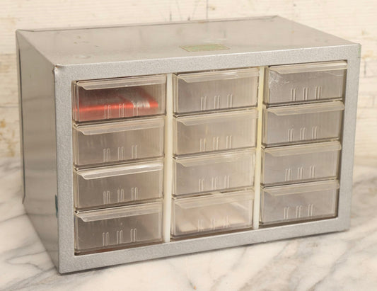 Lot 123 - Vintage A-M Cabinets Silver Metal 21-Drawer Parts Organizer With Original Paper Advertising And Labeling Supplies, Manufactured By Akro-Mils, Akron, Ohio
