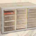 Lot 123 - Vintage A-M Cabinets Silver Metal 21-Drawer Parts Organizer With Original Paper Advertising And Labeling Supplies, Manufactured By Akro-Mils, Akron, Ohio