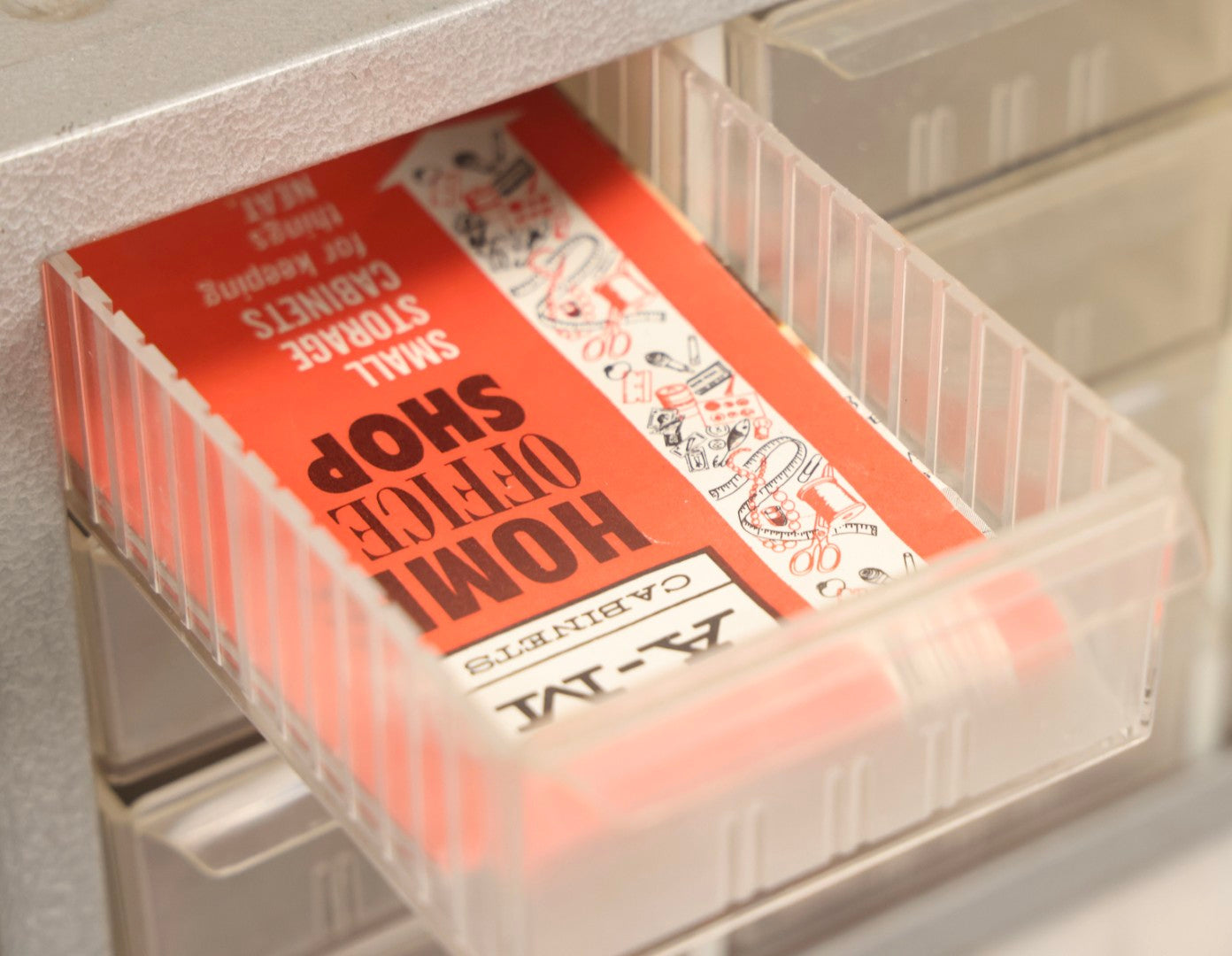 Lot 123 - Vintage A-M Cabinets Silver Metal 21-Drawer Parts Organizer With Original Paper Advertising And Labeling Supplies, Manufactured By Akro-Mils, Akron, Ohio