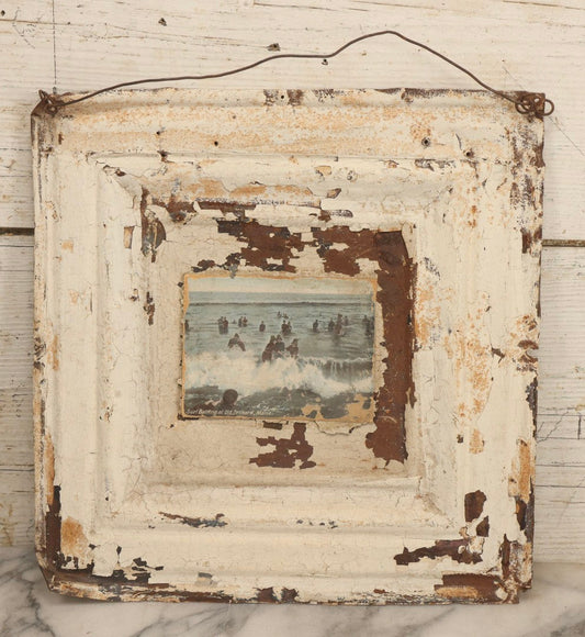 Lot 130 - Antique Pressed Tin Ceiling Tile Wall Hanging With White Paint, Pasted Postcard Of Surf Bathing At Old Orchard, Maine, Wire Hanger