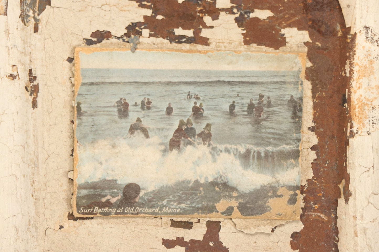 Lot 130 - Antique Pressed Tin Ceiling Tile Wall Hanging With White Paint, Pasted Postcard Of Surf Bathing At Old Orchard, Maine, Wire Hanger