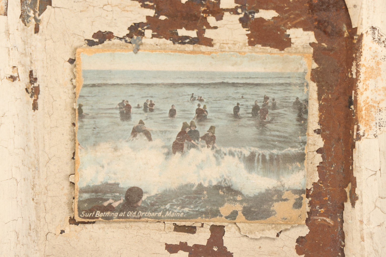 Lot 130 - Antique Pressed Tin Ceiling Tile Wall Hanging With White Paint, Pasted Postcard Of Surf Bathing At Old Orchard, Maine, Wire Hanger