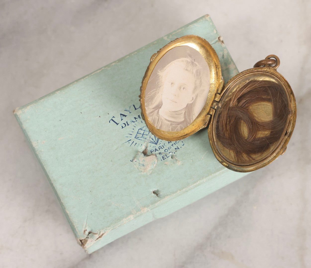 Lot 015 - Antique Victorian Gilt Metal Hair Locket With Turquoise Glass Cabochons, Portrait Photograph And Hair Keepsake, In Taylor's Diamonds Box