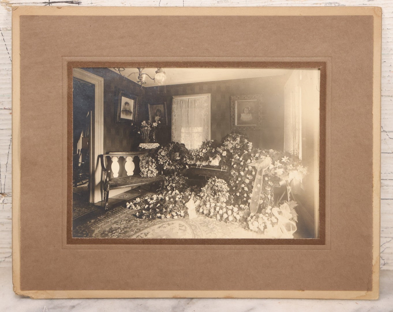 Lot 018 - Antique Board-Mounted Photograph Depicting Funeral Of Charles D. Brown, Died March 29, 1921, Home Parlor Setting With Casket And Floral Arrangements
