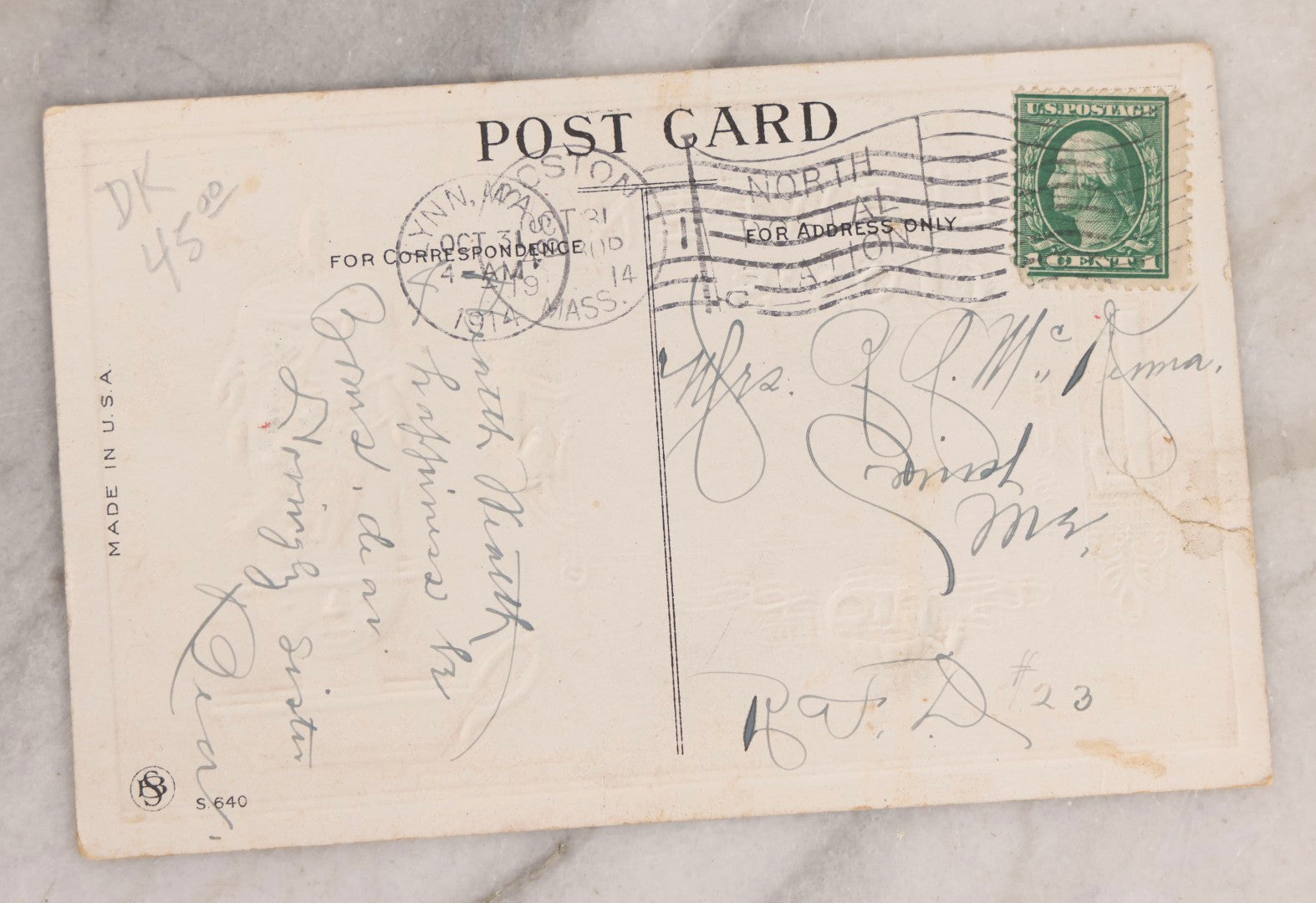 Lot 052 - Antique Embossed Halloween Postcard Featuring Witch On Candle With Black Cat, Jack-O-Lantern J.O.L. Smoking A Pipe, Faces In The Candlestand And Candle Wax, And Witch's Shadow, Made In U.S.A.., Postmarked October 31, 1914