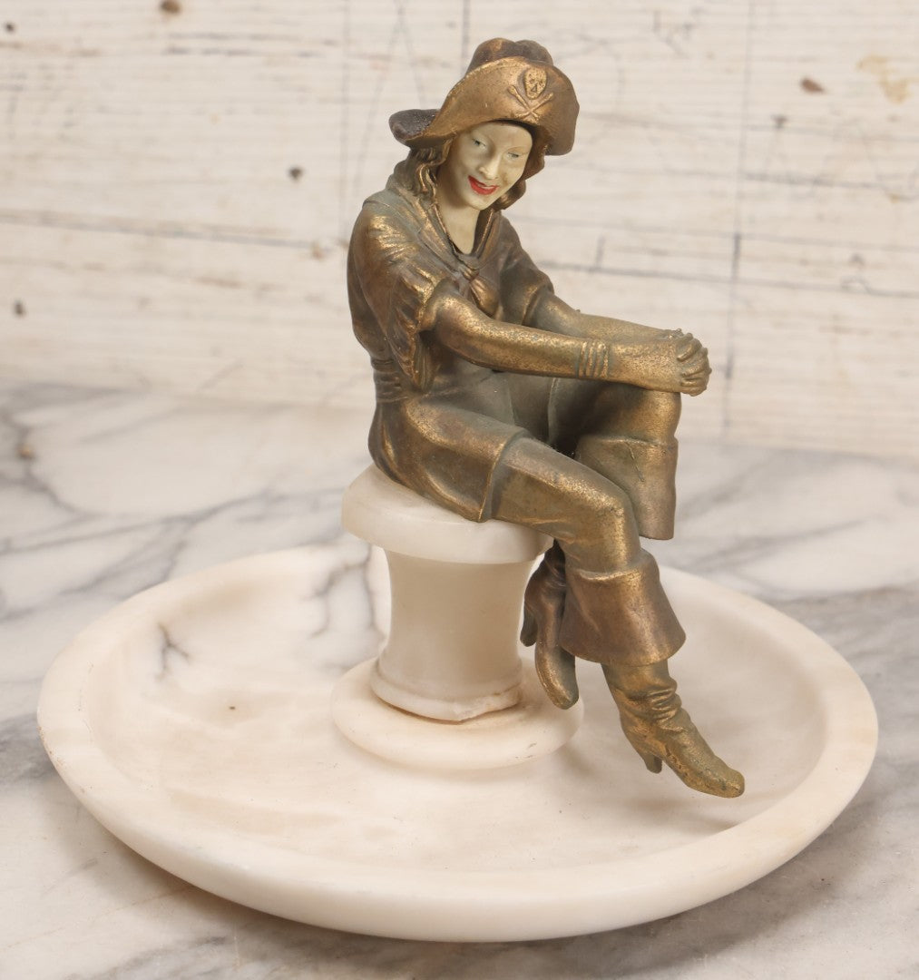 Lot 082 - Antique Alabaster Ashtray With Metal Female Pirate Figure Seated On Pedestal, Note Loss To Pedestal Base, Loosening Bolt