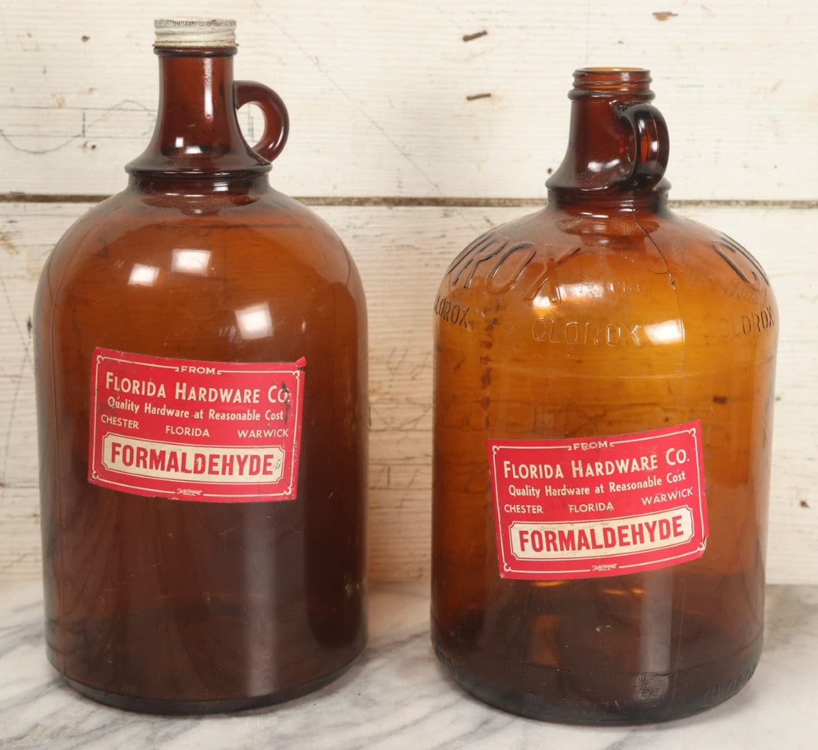 Lot 088 - Pair Of Vintage Amber Glass Jugs With Later-Applied Red “Formaldehyde” Paper Labels From Florida Hardware Co.
