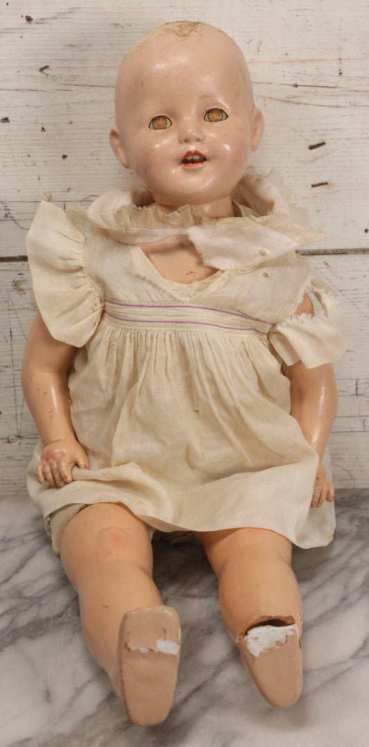 Lot 093 - Vintage Composition Baby Doll With Yellowed Sleep Eyes And Original Outfit, Missing Wig, Damaged Foot