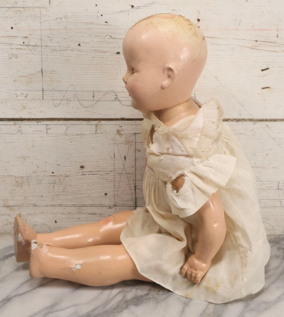 Lot 093 - Vintage Composition Baby Doll With Yellowed Sleep Eyes And Original Outfit, Missing Wig, Damaged Foot