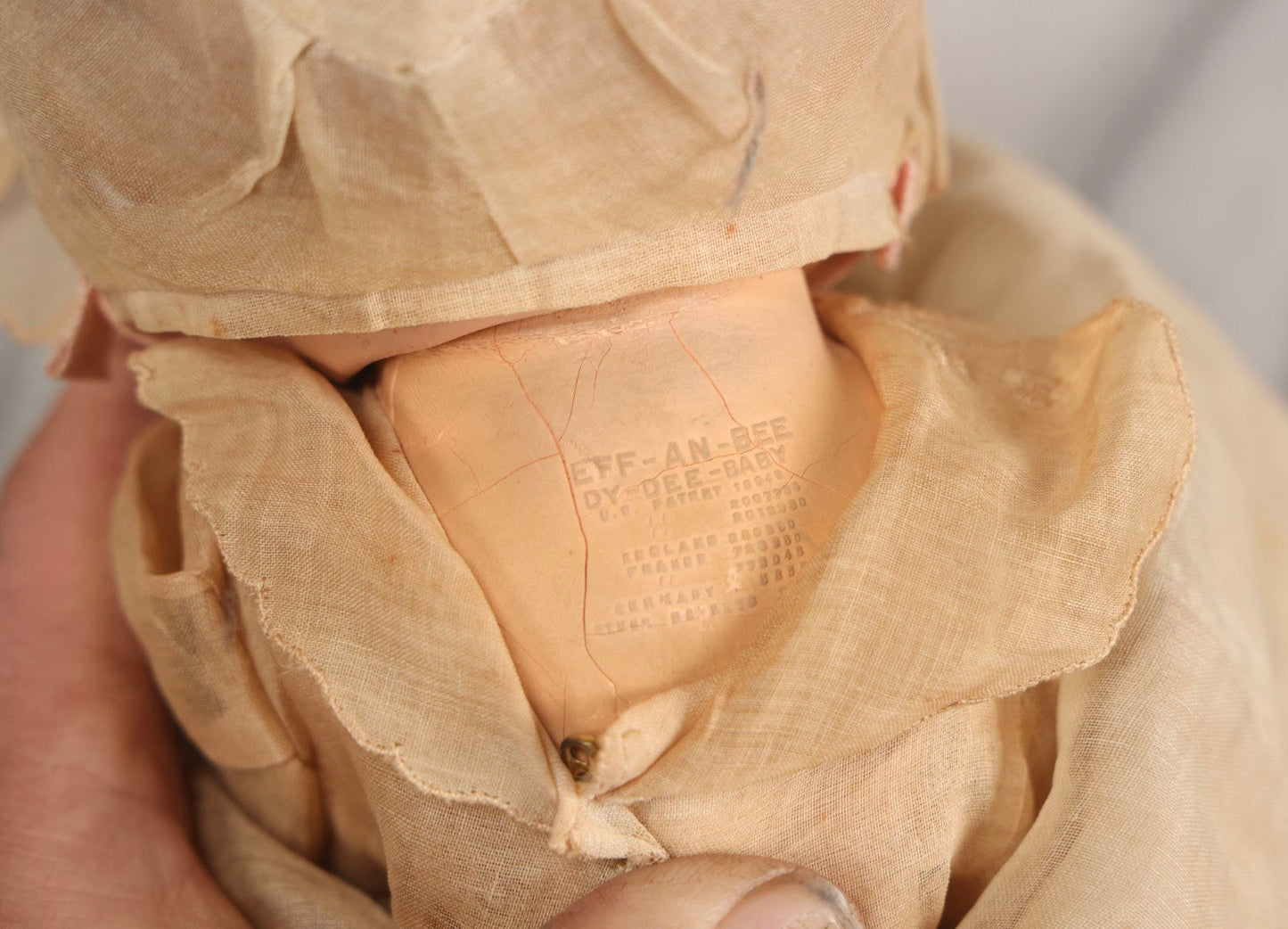 Lot 094 - Trio Of Vintage Composition Baby Dolls Including Floral Dress, Sheer Gown With Bonnet, And Plain Tan Undergarment