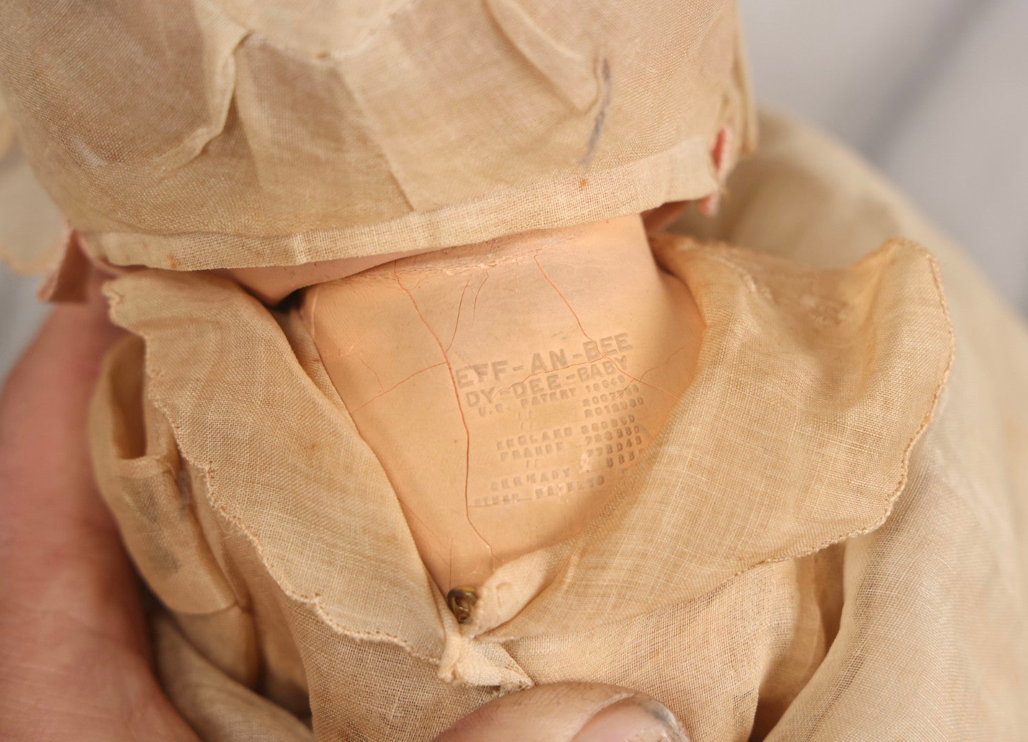 Lot 094 - Trio Of Vintage Composition Baby Dolls Including Floral Dress, Sheer Gown With Bonnet, And Plain Tan Undergarment