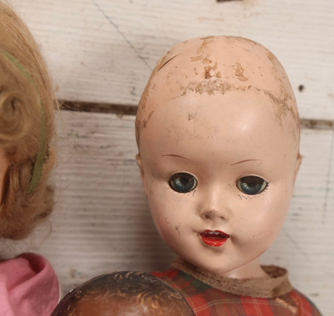 Lot 096 - Grouping Of Five Vintage Composition Dolls Including Floral Dress Doll, Plaid Dress Doll, Blue Check Dress Doll With Bonnet, Brown Composition Baby, And Small Jointed Doll