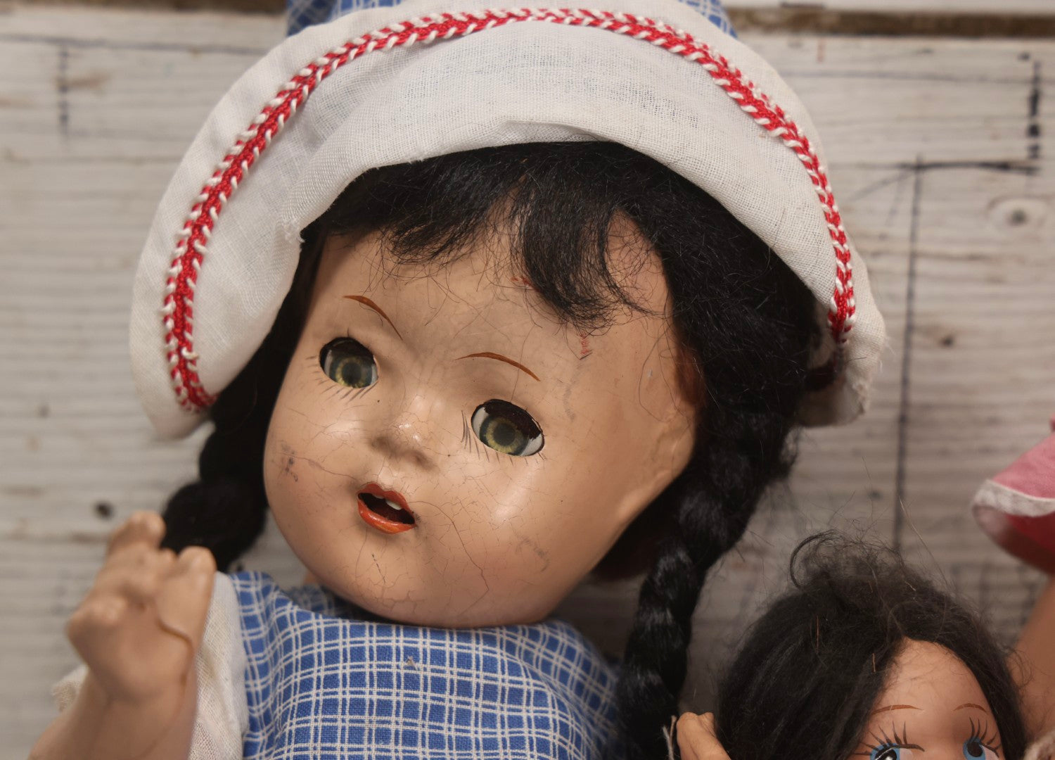 Lot 096 - Grouping Of Five Vintage Composition Dolls Including Floral Dress Doll, Plaid Dress Doll, Blue Check Dress Doll With Bonnet, Brown Composition Baby, And Small Jointed Doll