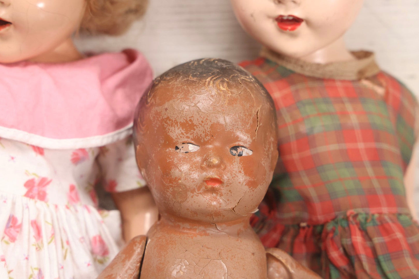 Lot 096 - Grouping Of Five Vintage Composition Dolls Including Floral Dress Doll, Plaid Dress Doll, Blue Check Dress Doll With Bonnet, Brown Composition Baby, And Small Jointed Doll