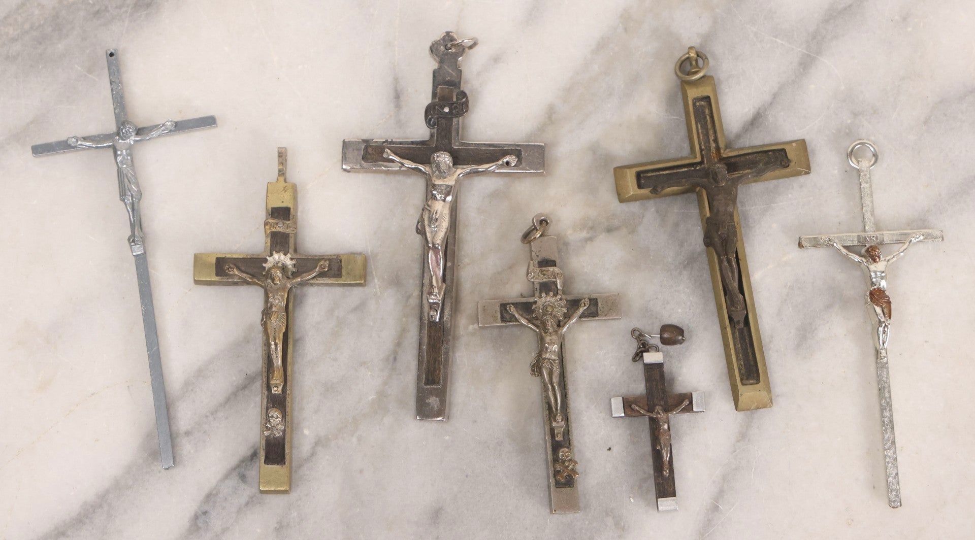 Lot 111 - Grouping Of Seven Vintage Crosses In Wood, Metal, And Plastic Including Two Golgotha Pectoral Crucifixes With Skull And Crossbones Motif