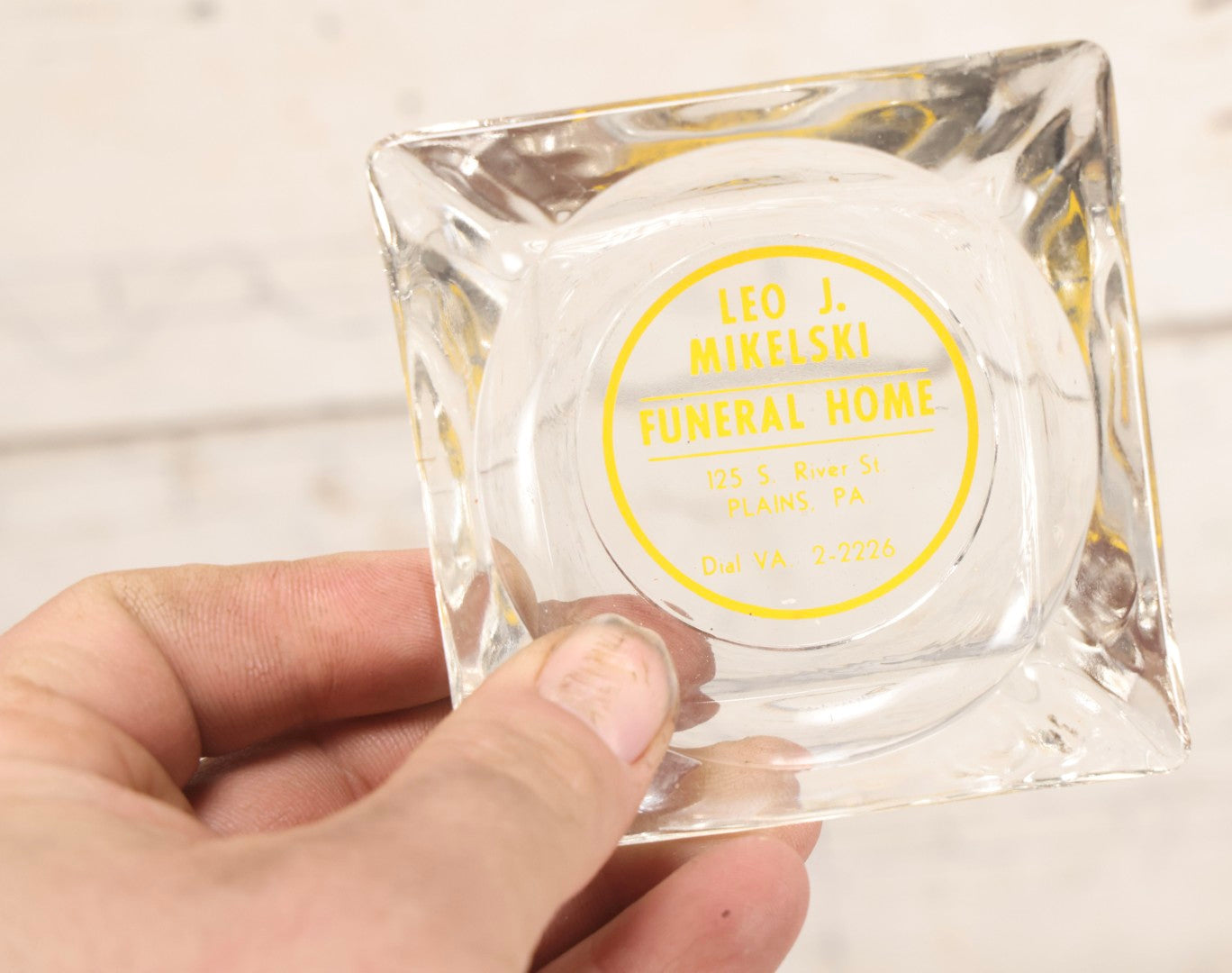 Lot 119 - Vintage Clear Glass Funeral Home Advertising Ashtray With Yellow Lettering For Leo J. Mikelski Funeral Home, Plains, Pennsylvania