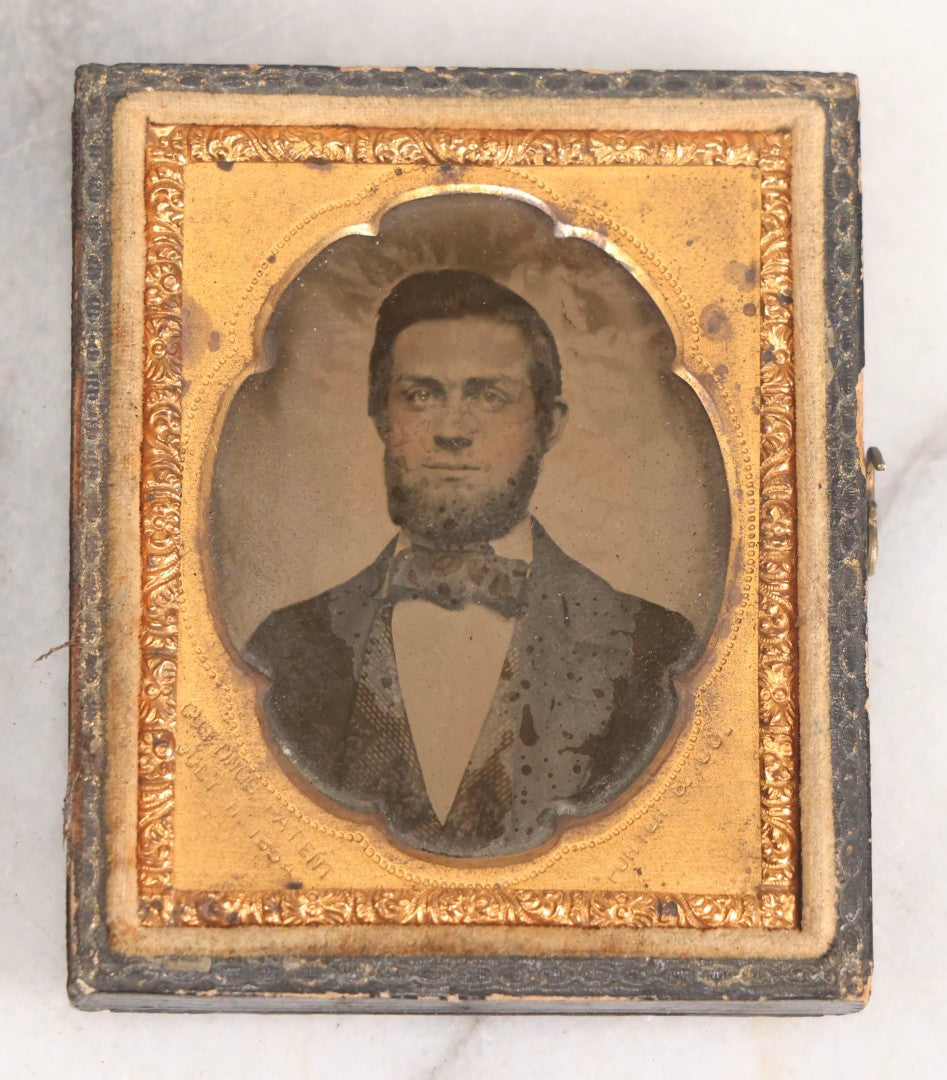 Lot 131 - Antique 1/9th Plate Ambrotype Photograph Of Young Bearded Man With Bowtie In Case With Cutting's Patent Brass Mat, Photographed By Porter & Co.