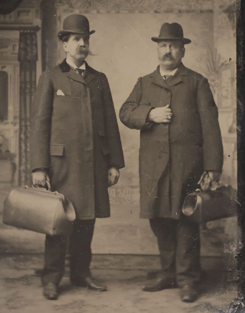 Lot 139 - Antique Uncased Tintype Photograph Of Two Men In Studio Interior Holding Doctor-Style Bags