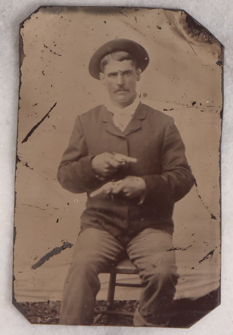 Lot 142 - Antique Late 19th Century Tintype Photograph Of Seated Man Holding Two Pistols, Uncased
