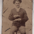 Lot 142 - Antique Late 19th Century Tintype Photograph Of Seated Man Holding Two Pistols, Uncased