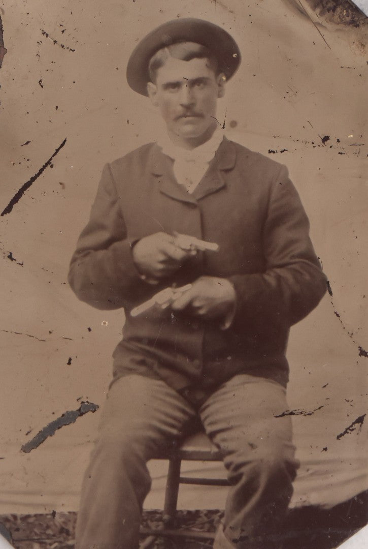 Lot 142 - Antique Late 19th Century Tintype Photograph Of Seated Man Holding Two Pistols, Uncased