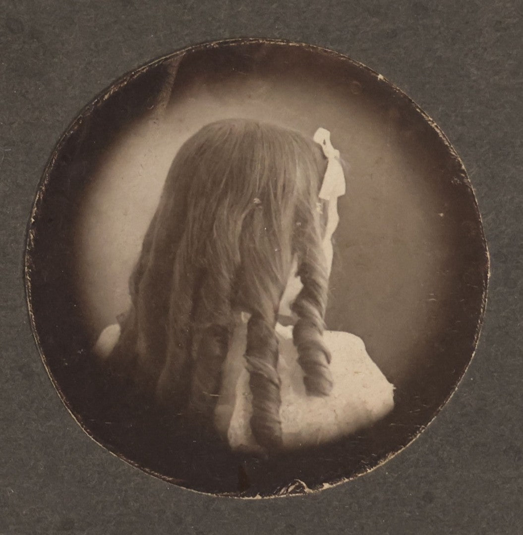 Lot 147 - Antique Small Size Boarded Photograph Of Young Girl With Curly Hair Viewed From The Back