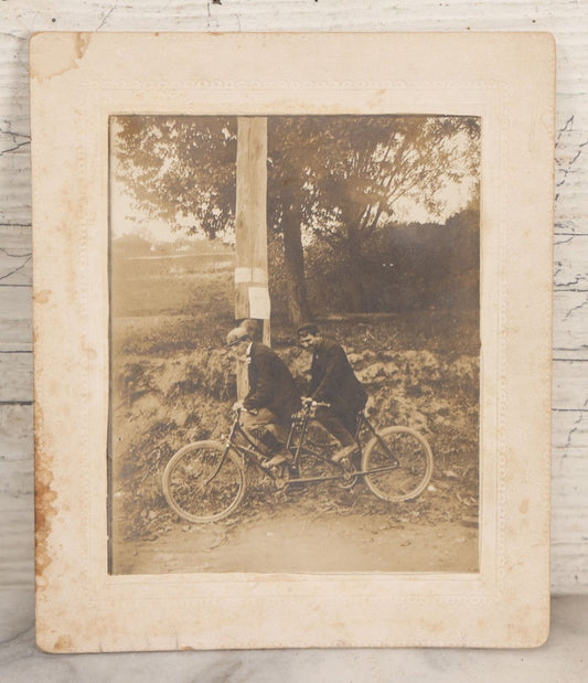 Lot 162 - Antique Boarded Photograph Of Two Young Men In Hats Riding A Tandem Bicycle