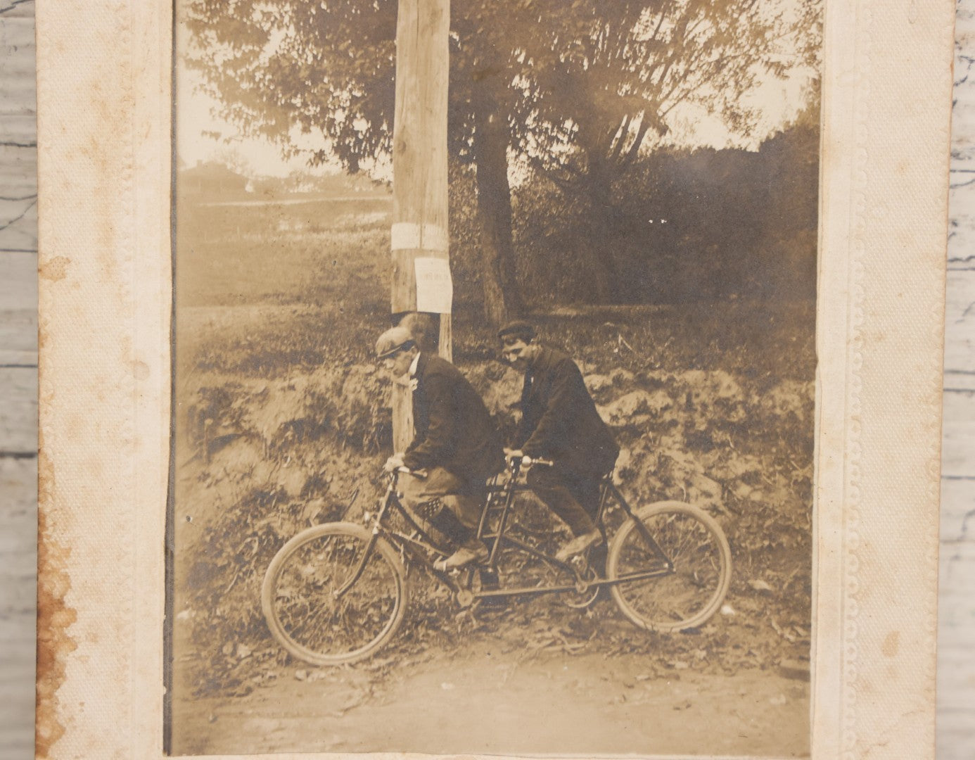 Lot 162 - Antique Boarded Photograph Of Two Young Men In Hats Riding A Tandem Bicycle