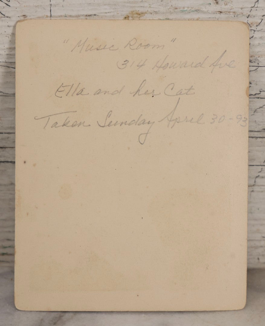Lot 163 - Antique Boarded Interior Photograph Of Girl Identified As Ella In “Music Room” With Toy Cat, Dated April 30, 1893