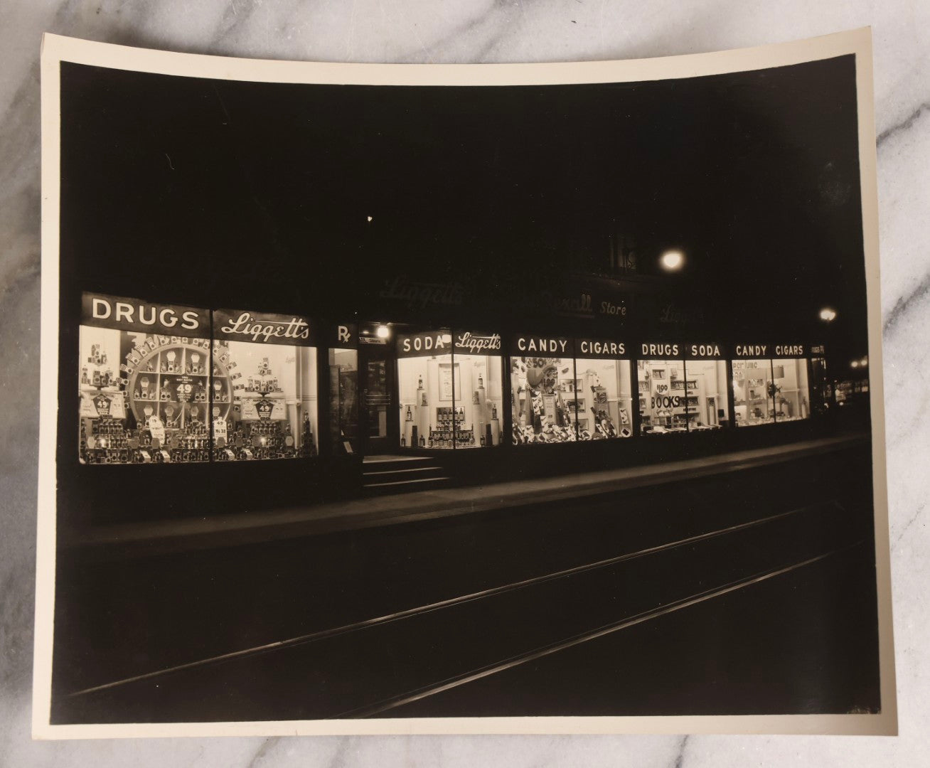 Lot 167 - Grouping Of 17 Glossy Unmounted Photographs Of Liggett's Rexall Store Window Advertising Displays, Circa 1940s