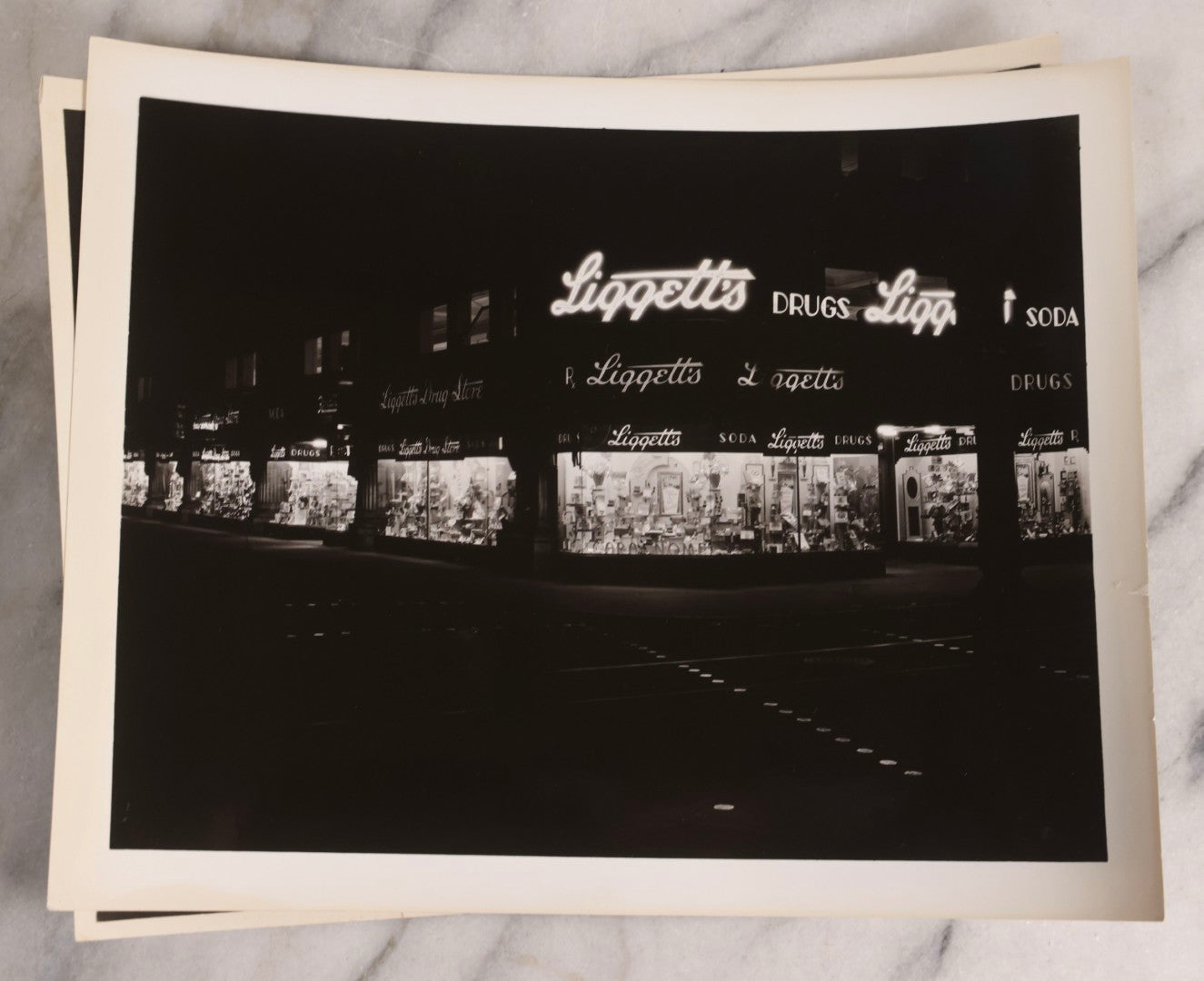Lot 167 - Grouping Of 17 Glossy Unmounted Photographs Of Liggett's Rexall Store Window Advertising Displays, Circa 1940s