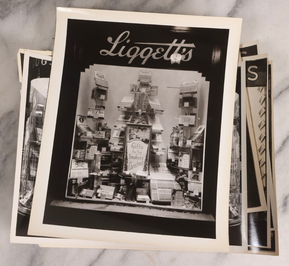 Lot 167 - Grouping Of 17 Glossy Unmounted Photographs Of Liggett's Rexall Store Window Advertising Displays, Circa 1940s