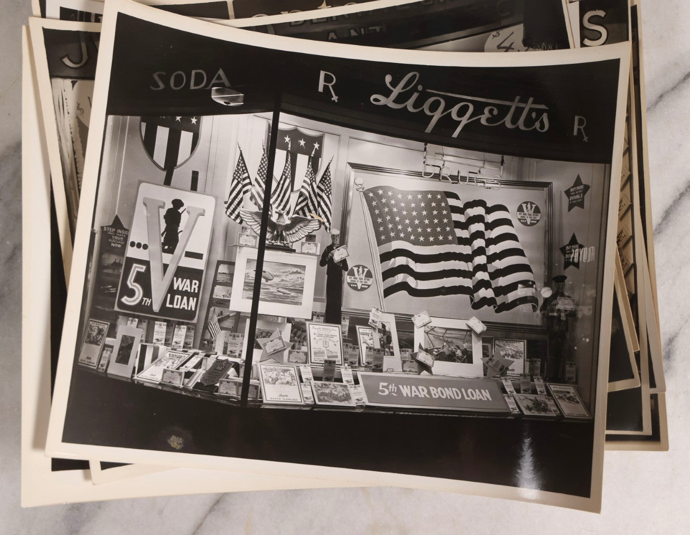 Lot 167 - Grouping Of 17 Glossy Unmounted Photographs Of Liggett's Rexall Store Window Advertising Displays, Circa 1940s