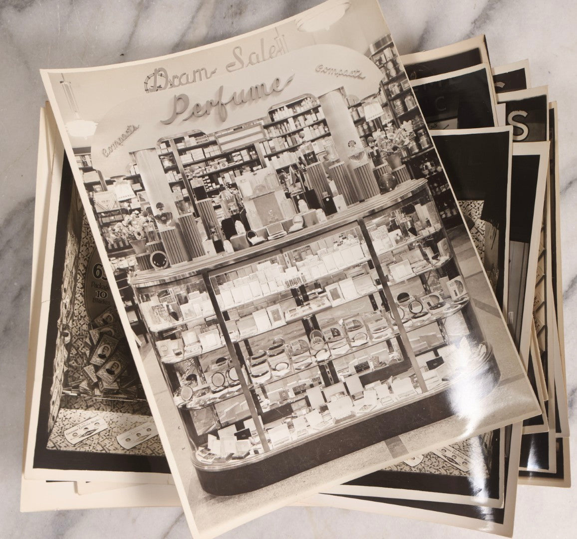 Lot 167 - Grouping Of 17 Glossy Unmounted Photographs Of Liggett's Rexall Store Window Advertising Displays, Circa 1940s