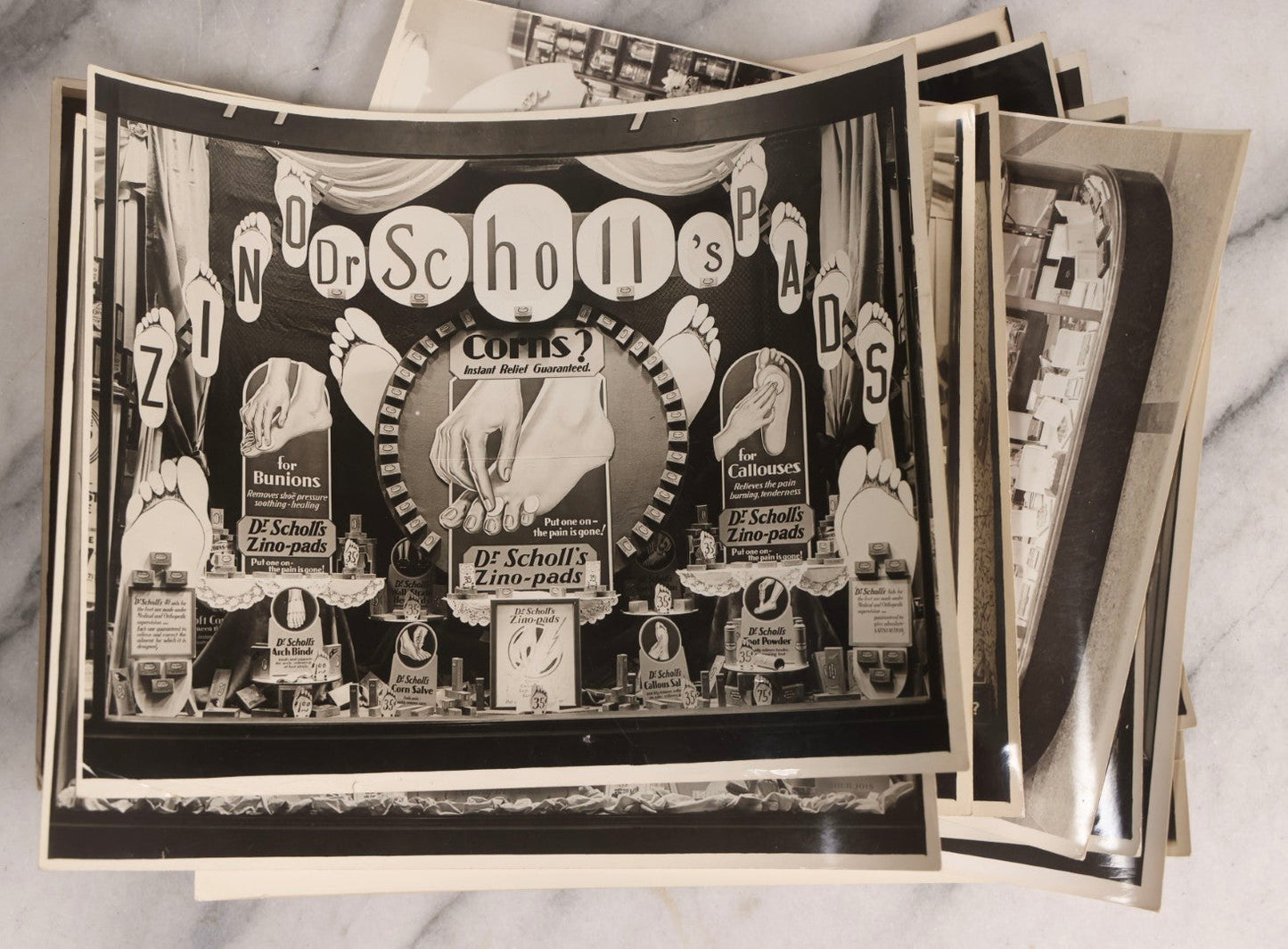 Lot 167 - Grouping Of 17 Glossy Unmounted Photographs Of Liggett's Rexall Store Window Advertising Displays, Circa 1940s