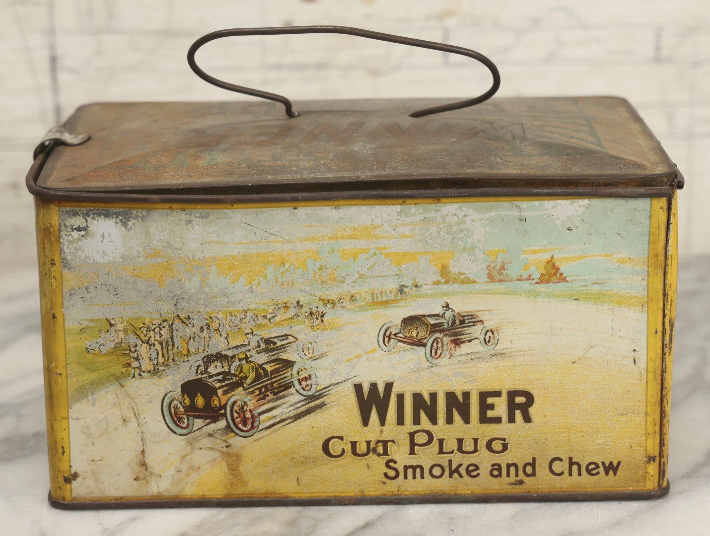Lot 188 - Antique Tin Lithograph "Winner Cut Plug Smoke And Chew" Tobacco Tin With Auto Racing Motif, J. Wright Co., Richmond, Virginia, Circa 1910–1920